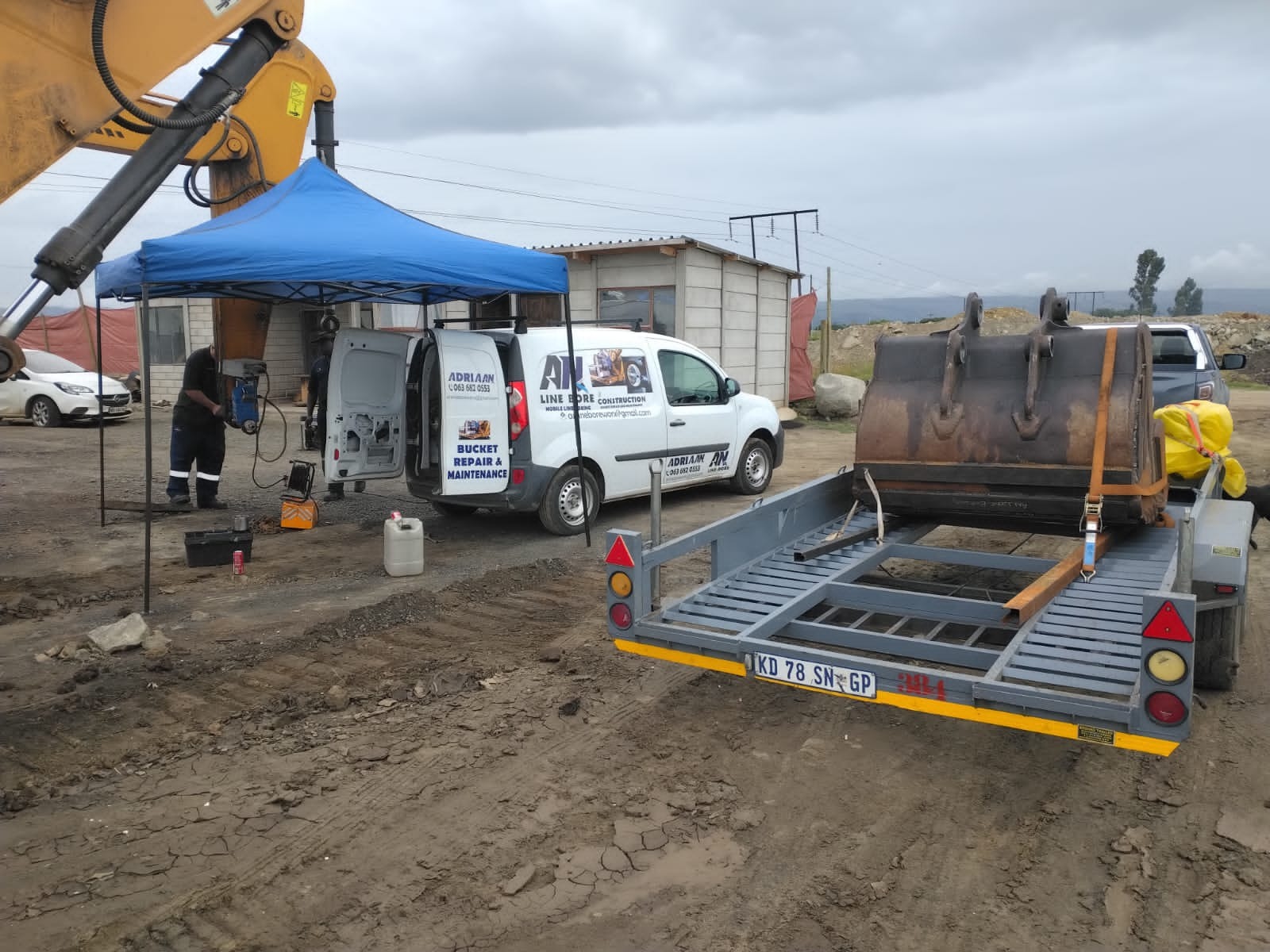AN Line-Bore branded service van on-site with bucket on trailer