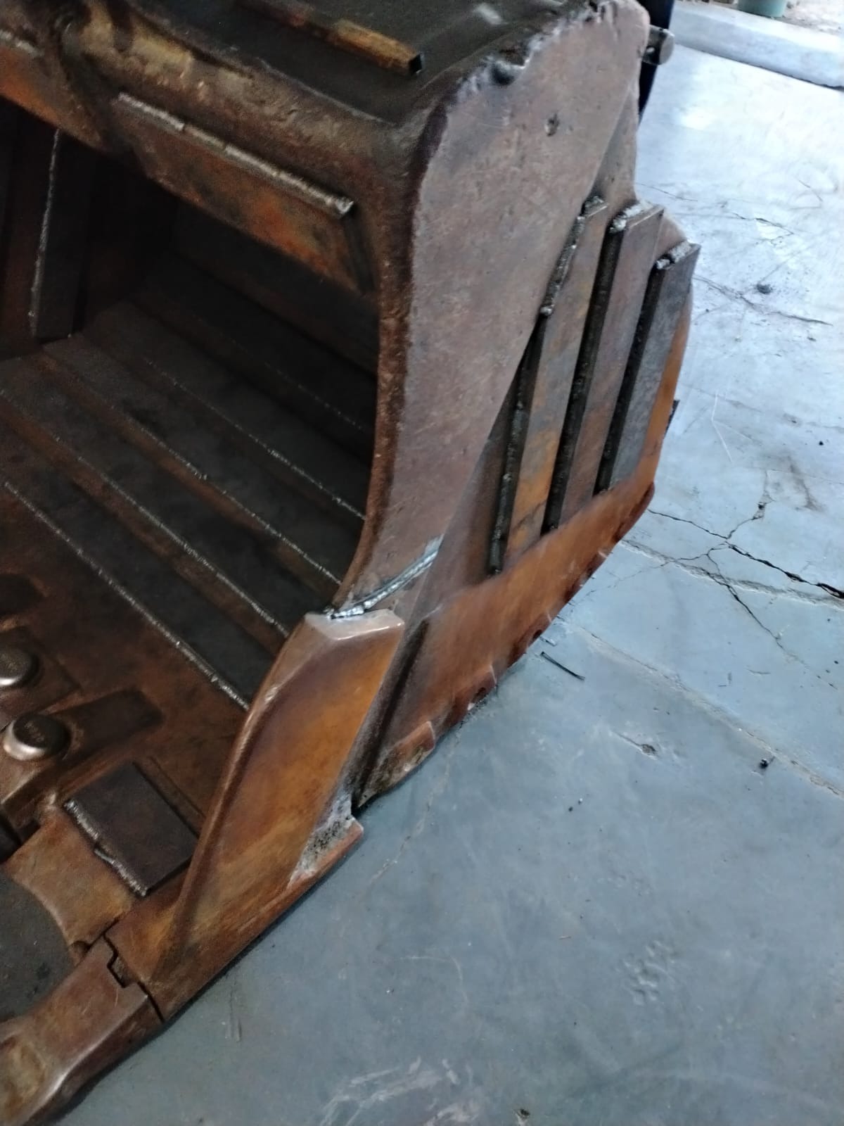 Rebuilt bucket showing fresh wear strips and welds