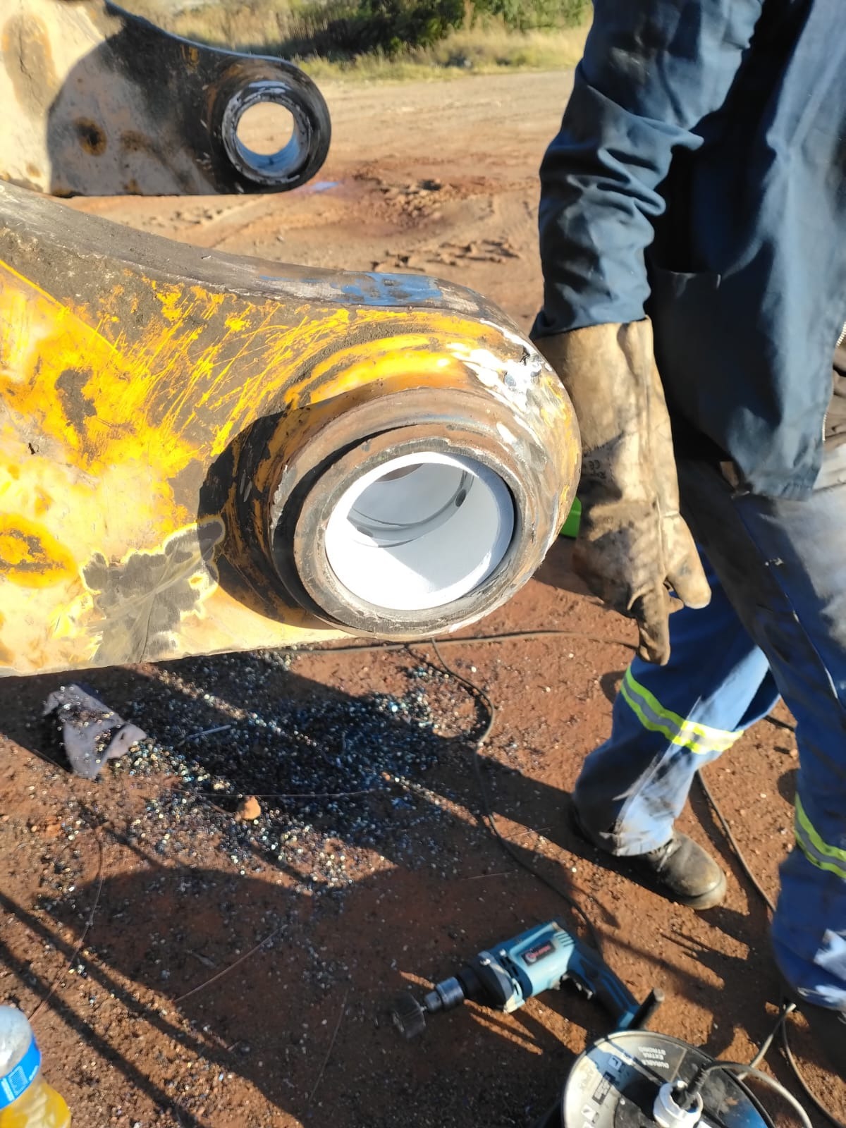 Technician inspecting newly fitted pin bush